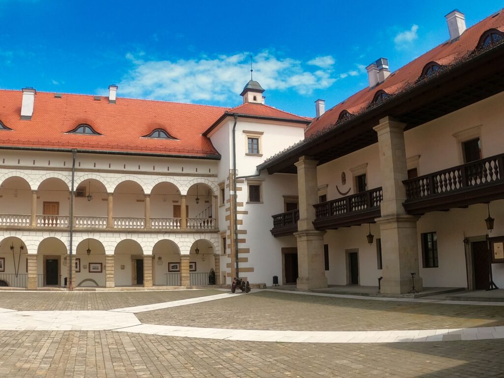 the courtyard of the Niepolomice Royal Castle with picturesque cloisters